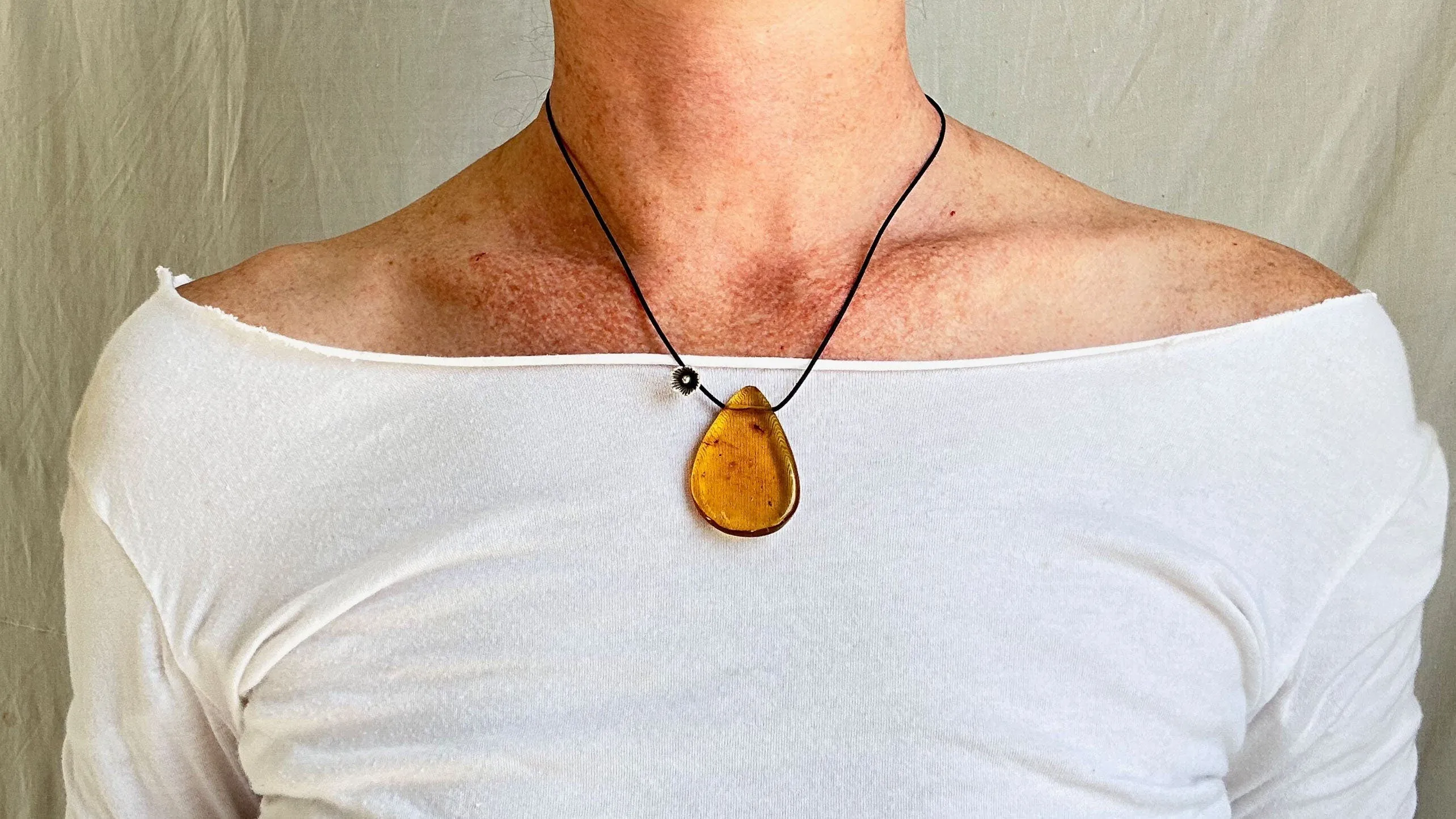 Large Amber Pendant on a Leather Cord. 1428. IN COMPLIANCE