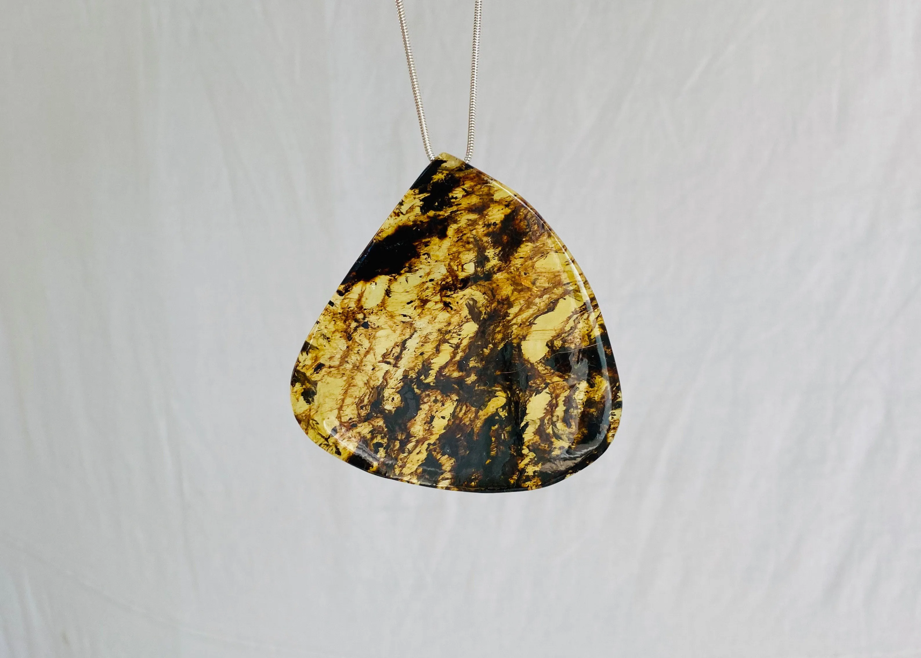 Large Amber Pendant on a Silver Cord. Snake Chain.