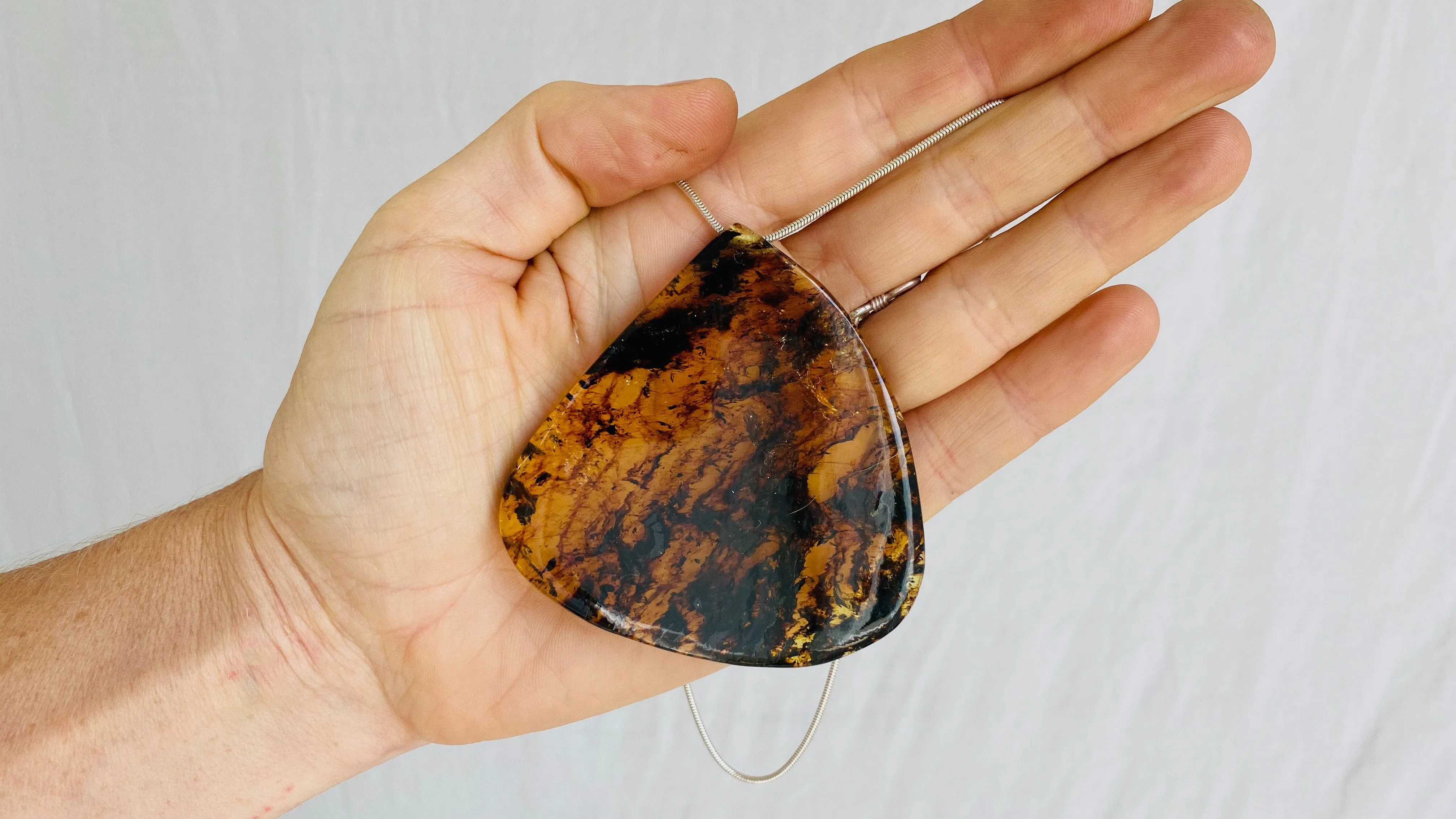 Large Amber Pendant on a Silver Cord. Snake Chain.